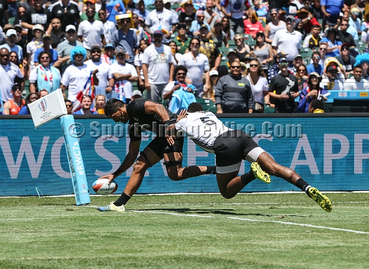 2018RugbySevensSun-13.JPG - New Zealand player Dylan Collier scores a try against Fiji player Semi Kunatani (5) in the men's championship semi finals match in the 2018 Rugby World Cup Sevens, Sunday, July 22, 2018, at AT&T Park, San Francisco. New Zealand defeated Fiji 22-17. (Spencer Allen/IOS via AP)